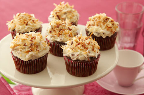 This is a pecan covered cupcake with frosting.